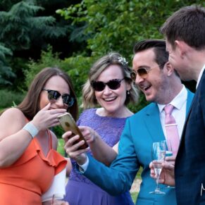 Informal capture of some wedding guests in the gardens during the drinks reception at Pendley Manor Hotel