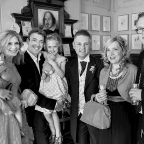 Wedding guests pose for the camera in the bar area at Pendley Manor Hotel