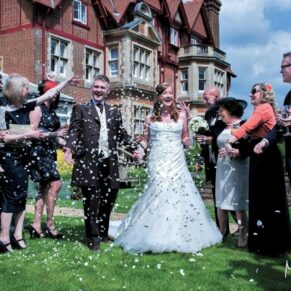 Fun confetti moment during the drinks reception for the bride and groom at their at Pendley Manor Hotel wedding