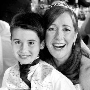 The bride captured informally with her son during the meal at her Pendley Manor Hotel wedding
