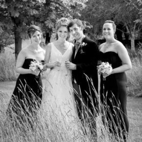 Runnymede Hotel Wedding Photography - the bride and groom in the meadow with their bridesmaids for some relaxed photos