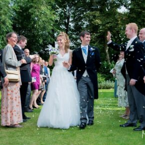 Runnymede Hotel Wedding Photography - the newlyweds make their way through the confetti aisle
