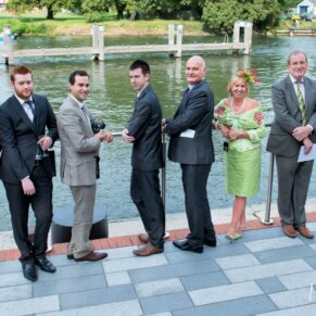 Runnymede Hotel Wedding Photography - guests relaxing by the waterside