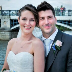 Sir Christopher Wren Hotel Wedding Photography - the newlyweds with Eton to Windsor Bridge and river behind them