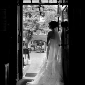 Sir Christopher Wren Hotel Wedding Photography - black and white silhouette shot of the bride in the main entrance doorway