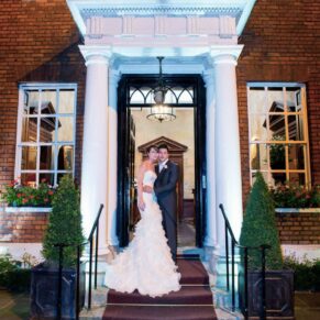 Sir Christopher Wren Hotel Wedding Photography - the newlyweds under the portico in the front doorway