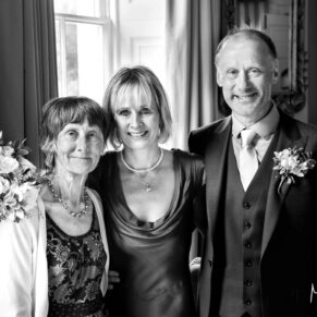 The bride and groom captured with mum by windowlight at their Saint Michael's Manor wedding