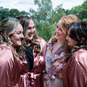 Swan at Streatley wedding - the bride giggling with her bridesmaids prior to the civil ceremony