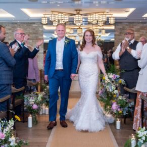 The smiling bride and groom exit their civil ceremony at their Swan at Streatley wedding