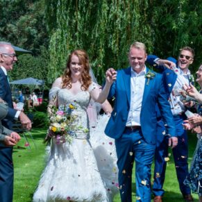 Swan at Streatley wedding - confetti aisle with the bride and groom making a dash past their guests
