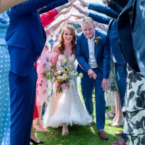 The newlyweds make their way through a human arch after their wedding ceremony at the Swan at Streatley for a perfect photography opportunity