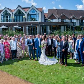 Swan at Streatley wedding photography group pose of everyone in the hotel gardens with the hotel in the background