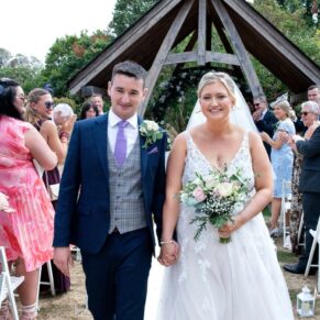 The newlyweds exit the ceremony to lots of cheers at their Tudor Barn wedding