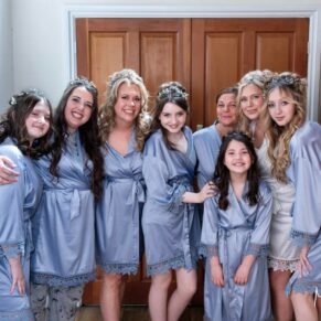 The ladies posing for a group shot in their dressing gowns before the ceremony