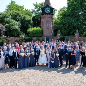 The shot of everyone in front of the clock tower at the Tudor Barn