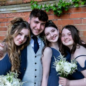 The bridesmaids and the best man in the Tudor Barn folly strike a pose for the camera