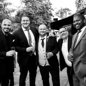 Guests enjoying the outdoor drinks reception at the Tudor Barn