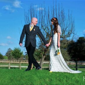 The newlyweds take a stroll under perfect blue skies for this capture