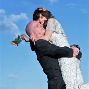 A fun and embracing hug from the bride and groom at their glorious Tudor Barn wedding