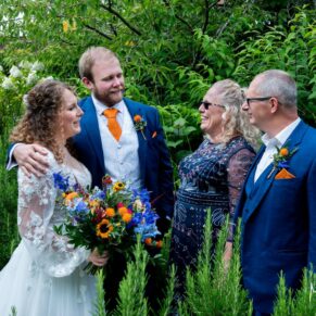The Olde Bell Hurley Wedding Photography - the newlyweds with their parents having a chat