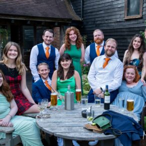 Casual group pose of some of the guests around a table in The Olde Bell's courtyard in the village of Hurley