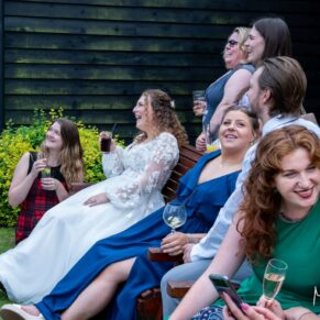 The wedding guests enjoying the banter during the drinks reception at the front of this historic barn at The Olde Bell Hotel in Hurley