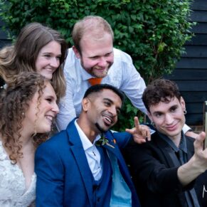 Selfie time for the newlyweds and their wedding guests during the lively drinks reception at their Olde Bell in Hurley wedding reception