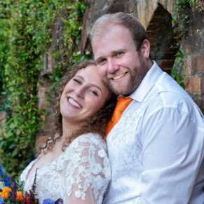 A portrait in the gardens of the bride and groom against an ivy clad wall at their Olde Bell in Hurley wedding reception