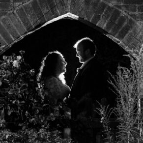 Silhouette portrait captured at night-time in the gardens of the newlyweds at their Olde Bell in Hurley wedding reception