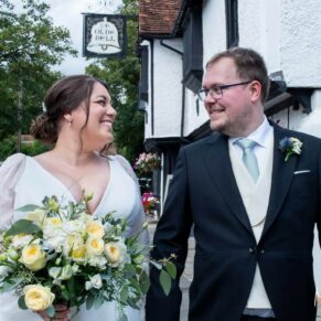 The newlyweds take a stroll at the front of the The Olde Bell in Hurley on their wedding day to capture a few moments together away from the guests