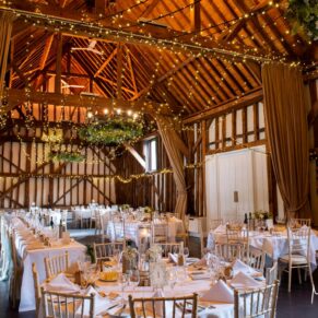 Stunning barn interior all setup for the meal at this wonderful wedding at The Olde Bell in Hurley