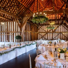 The striking 16th Century tithe barn interior at The Olde Bell in Hurley never fails to impress with its six metre high ceilings, aged oak beams and rafters! As a photographer, backdrops don't get much better than this for an atmospheric wedding day. In every direction there's just so much to see and explore at this fabulous Berkshire wedding venue. Stunning interior shot of the historic barn all set for the wedding breakfast at The Olde Bell in Hurley