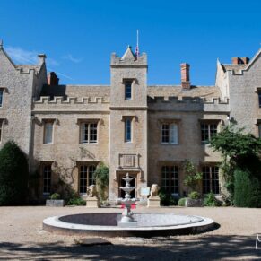 The stunning facade of this historic Weston Manor Hotel under perfect blue skies
