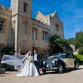 Bride and dad pose beside the car before leaving for the church at the front door entrance of Weston Manor Hotel