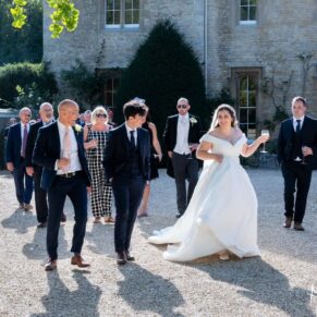 The bride walking with some family members along the hotel's main driveway