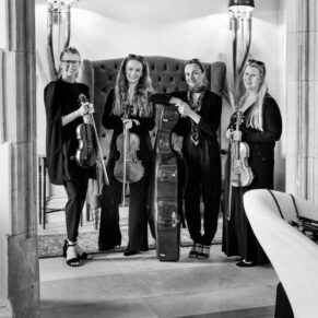 The musicians pose for the camera in the entrance area before they leave for the day after performing at Weston Manor Hotel