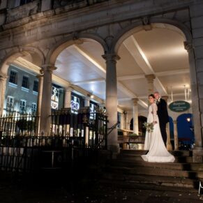 Photography of the newlyweds captured under the arches of the Guildhall in Windsor after dark on their Castle Hotel wedding day
