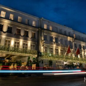 Photography of the Castle Hotel exterior in Windsor captured at night time with moving car headlights for this Christmas wedding