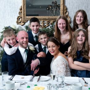 Photography of the newlyweds d with their children during the meal at their Castle Hotel wedding in Windsor