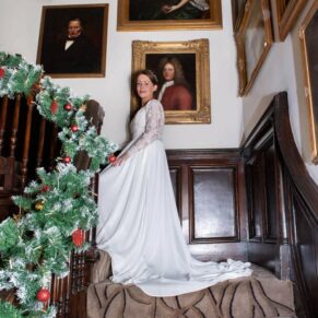 Photography of the bride captured on the Christmassy staircase prior to her wedding at the Castle Hotel in Windsor