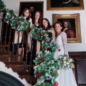 Photography of the bridal party as they gather on the staircase for a picture prior to the civil wedding ceremony at The Castle Hotel in Windsor