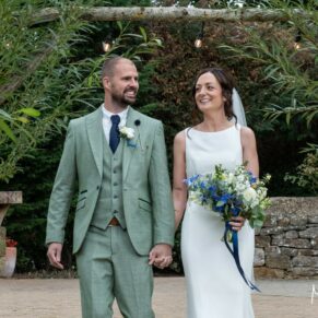 The bride and groom take a relaxing stroll through the colourful gardens