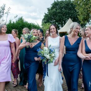 The giggling ladies larking around as they take a stroll with the bride