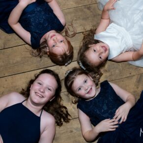 Kids laying on the dancefloor for a fun camera pose between the dances