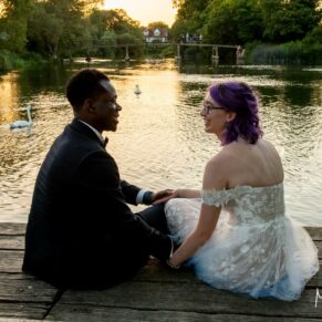 An atmospheric sunset pose of the Newlyweds next to the River Thames at their Great House in Sonning summer wedding