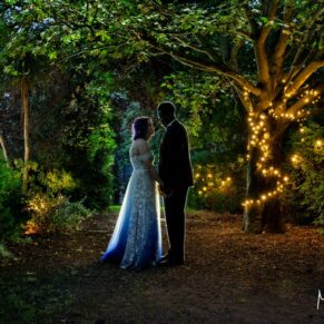 When night time arrives, I bring out my floodlighting for some dramatic poses of the newlyweds. For this silhouette pose captured in the village of Sonning, I took the couple into the Secret Garden. I'm using multiple lights to achieve the striking pose you see here amongst the trees. Atmospheric Silhouette pose at dusk of the newlyweds in the Secret Garden at their Great House wedding in the village of Sonning