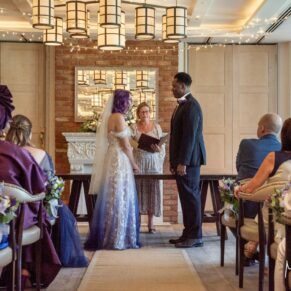 The exchange of the rings captured during the indoor wedding civil ceremony at the Great House in Sonning