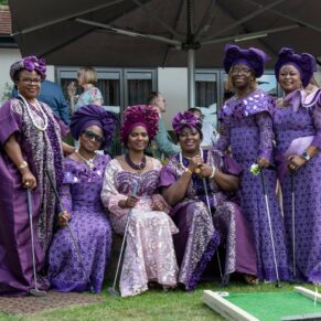 Some of the most colourfully dressed guests pose for the camera during a break from the crazy golf at this Great House in Sonning wedding drinks reception