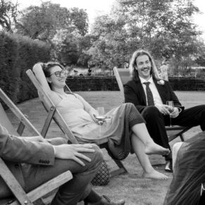 Just a chilling out sort of moment for the wedding guests as they enjoy the garden deck chairs at The Great House in Sonning