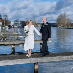 The bride and groom enjoy a walk along the river jetty in the town before their Hotel Du Vin Henley wedding reception